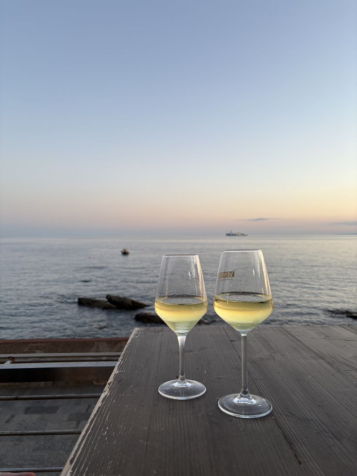 Wine glasses overlooking the water